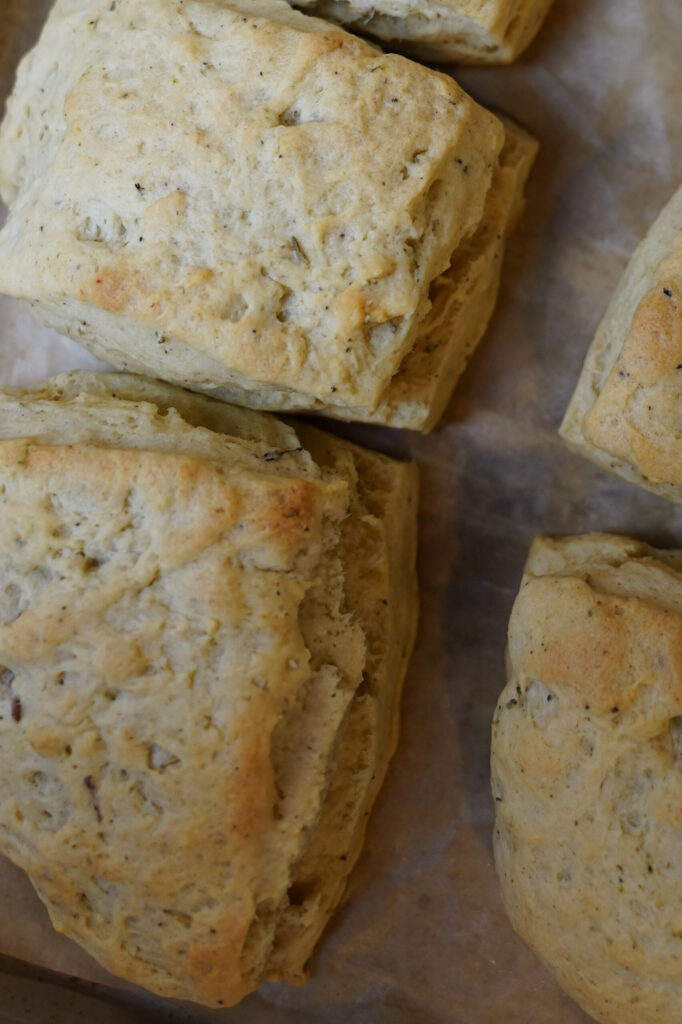autumn seasoned biscuits on parchment paper lined baking sheet.