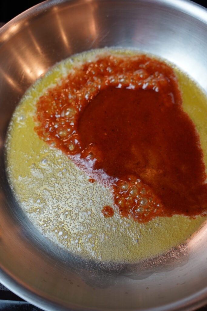 butter and brown sugar dijon glazed ham ingredients warming up in a stainless steel all clad pan.