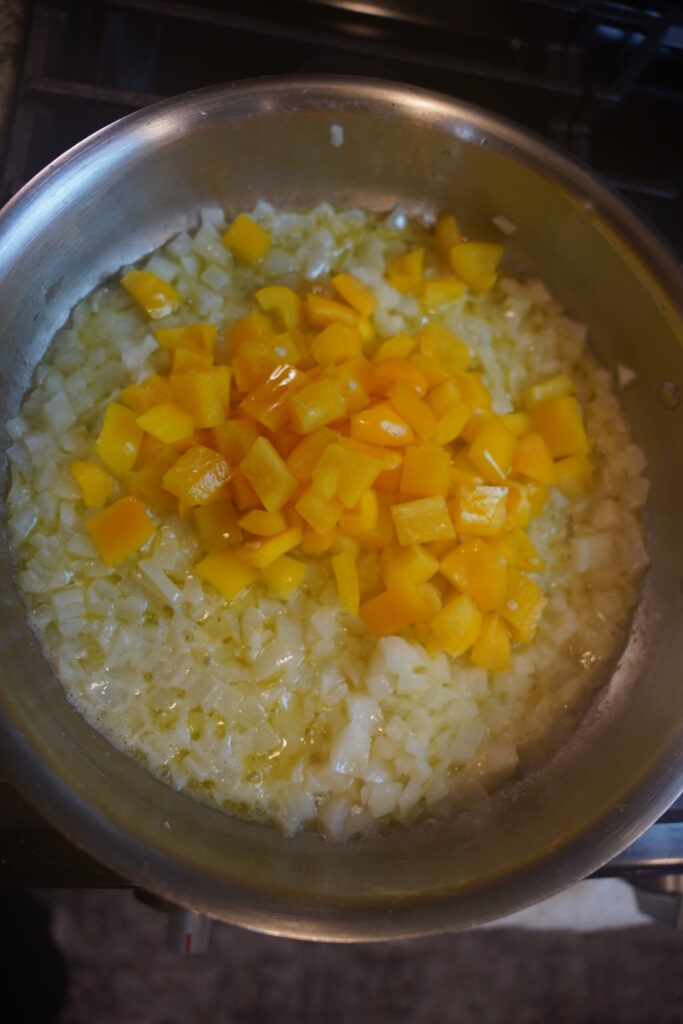 Cajun Shrimp Pasta Step 3. Butter melted, onion softened, garlic, and bell pepper in a large all clad stainless steel pan.