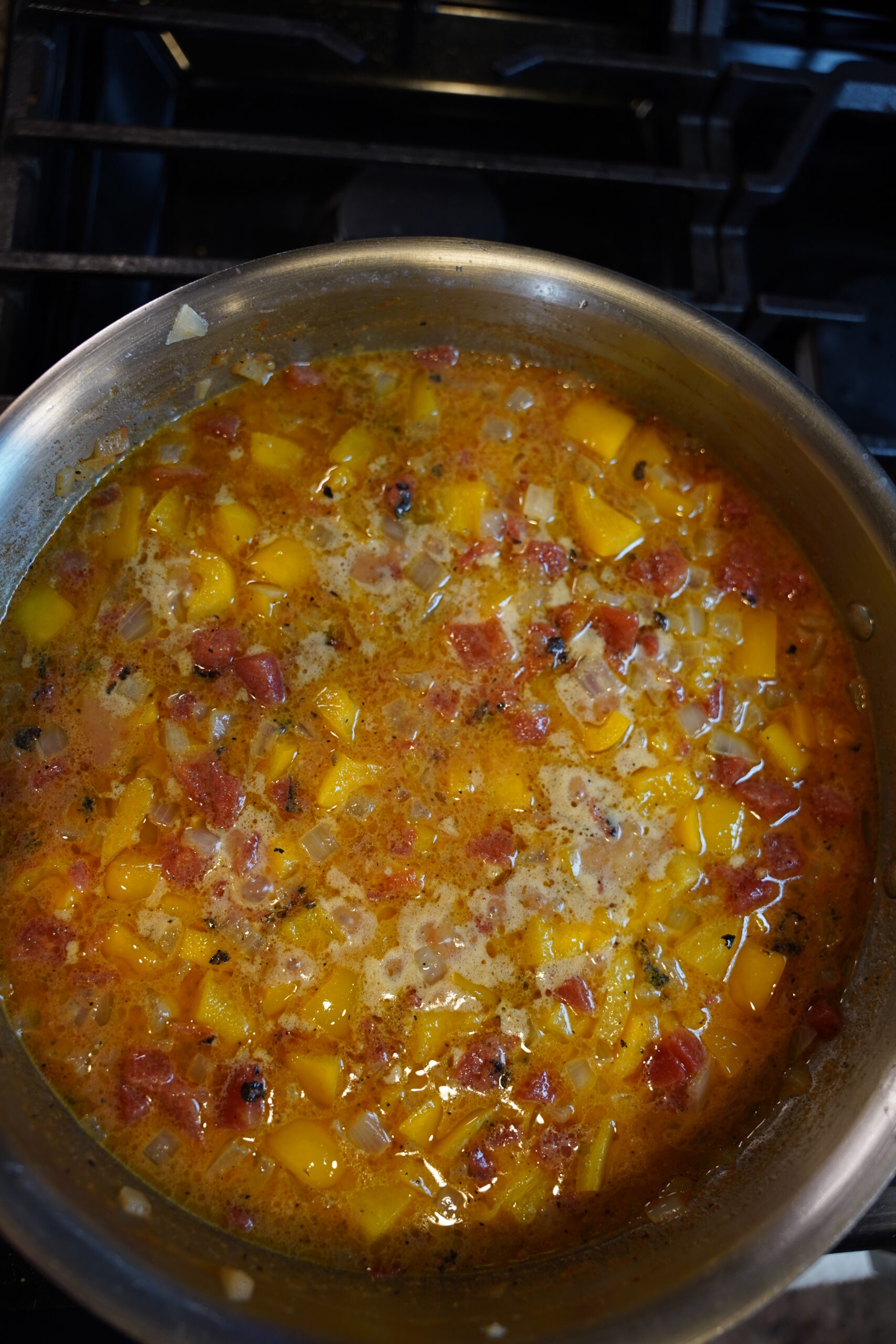 Cajun Shrimp Pasta Step 5. Butter melted, onion softened, garlic, and bell pepper with Muir Glen Fire Roasted Tomato with green chili, milk, parmesan, cream cheese, Cajun seasoning, chili powder, paprika, and chipotle smoked jalapeño powder (or smoked paprika) - in a large all clad stainless steel pan.