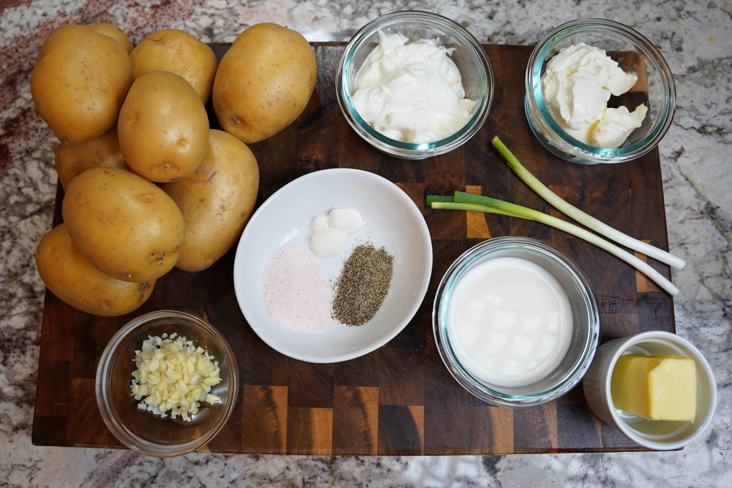 yukon gold potatoes with seasonings (salt, pepper, onion powder), green onion, butter, garlic, milk, sour cream, and cream cheese - best mashed potatoes ever. Chef level mashed potatoes ingredients.