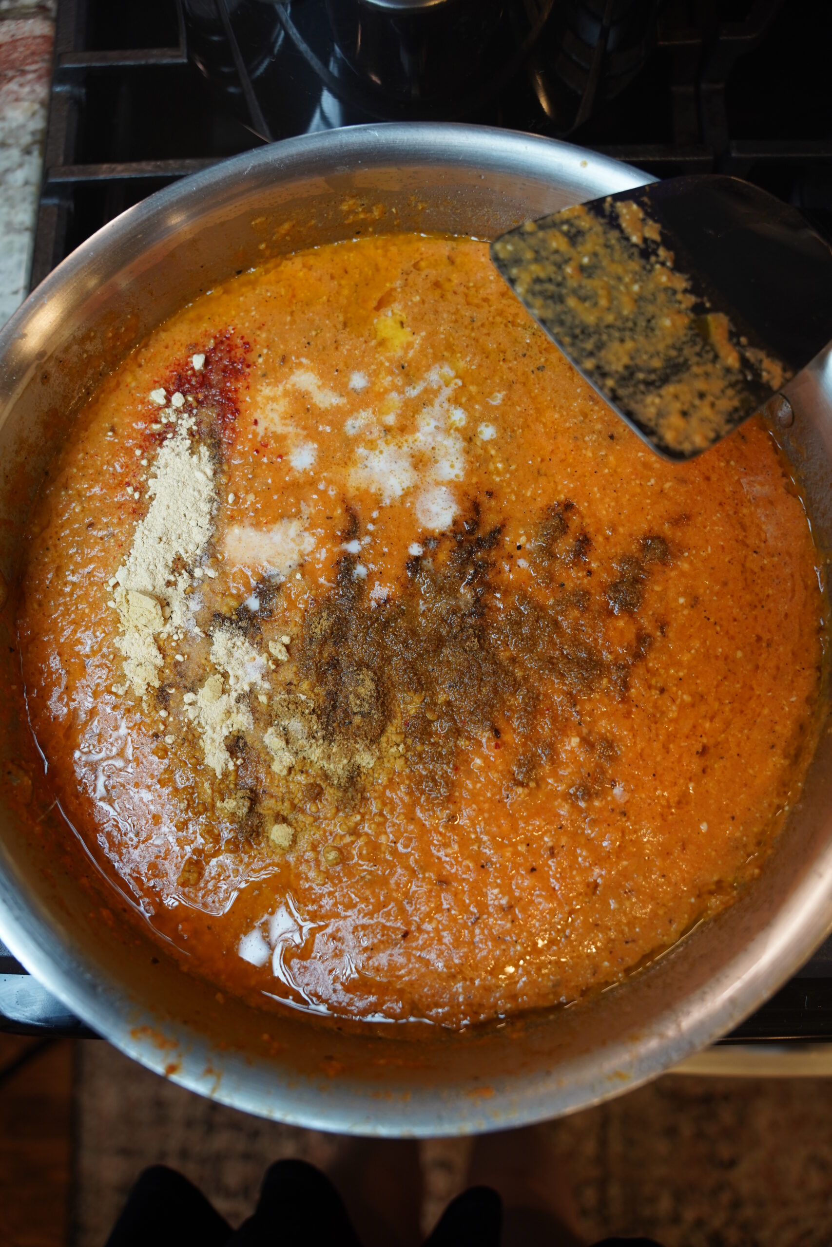 Curry sauce added to pan and other seasonings added.