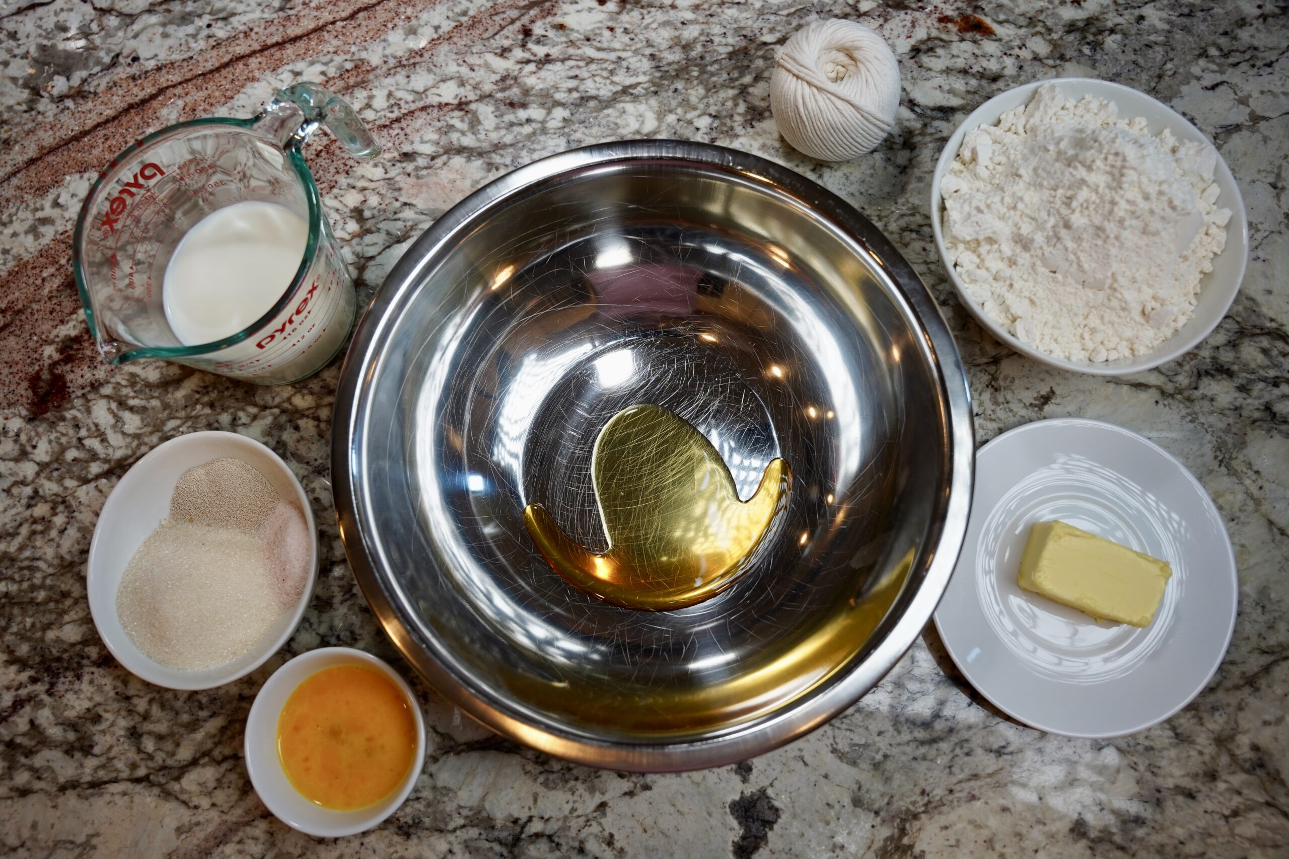 Pumpkin shaped dinner rolls ingredients. Honey, butter, warm milk, flour, 1 large whisked egg, active dry yeast, salt, and sugar.