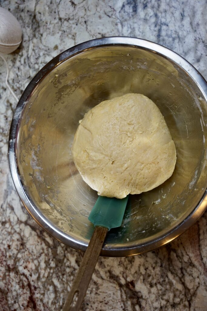 Pumpkin Shaped Dinner Rolls Dough after mixing flour into the wet ingredients. In a large metal mixing bowl.