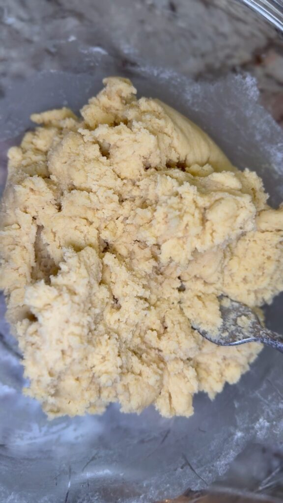 Snickerdoodle cookie dough in a large mixing bowl and ready for shaping