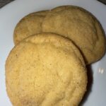 3 Completed Snickerdoodle Cookies, perfectly baked and sitting on a plate.