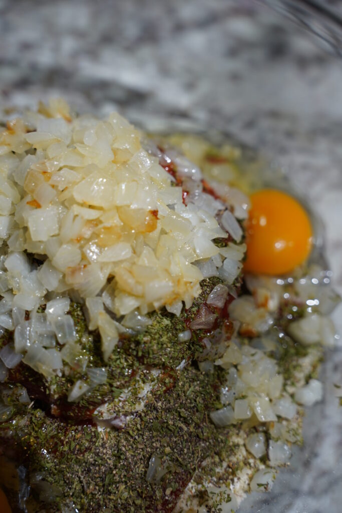 Meatloaf ingredients in a bowl before mixing.