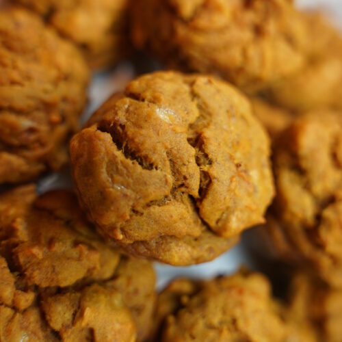 Pumpkin Banana Nut Muffins Completed, Stacked on a white plate, close up.